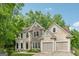 Charming two-story home with stone accents, manicured lawn, and an attached two-car garage at 3355 Golfe Links Dr, Snellville, GA 30039