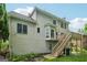 Rear exterior featuring a multi-level deck with stairs leading to the backyard at 3355 Golfe Links Dr, Snellville, GA 30039