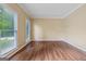 Spacious living room with ample natural light, neutral walls, and sleek wood flooring at 3355 Golfe Links Dr, Snellville, GA 30039