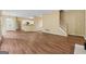 Open-concept living room with wood floors, staircase, and seamless flow to the modern kitchen at 3355 Golfe Links Dr, Snellville, GA 30039