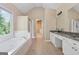 Elegant main bathroom featuring a soaking tub, separate shower, and spacious vanity at 3355 Golfe Links Dr, Snellville, GA 30039