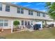 Landscaped backyard features a stone patio, seating, grilling space, and privacy fencing at 2083 Hasel St, Lawrenceville, GA 30044