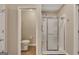 Bathroom featuring a walk-in shower behind sliding glass doors and a separate toilet at 2083 Hasel St, Lawrenceville, GA 30044
