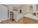 Bathroom featuring double sinks, large mirrors, and a separate tub and toilet at 2083 Hasel St, Lawrenceville, GA 30044