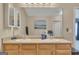 Bright bathroom featuring double sinks with a wooden cabinet and a large mirror at 2083 Hasel St, Lawrenceville, GA 30044