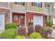 Close-up of a townhome entrance with brick facade, small window and landscaping at 2083 Hasel St, Lawrenceville, GA 30044