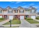Charming townhomes with brick and stone accents, individual garages, and well-maintained lawns at 2083 Hasel St, Lawrenceville, GA 30044