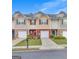 Attractive townhomes featuring colorful facades, private garages, and manicured front lawns at 2083 Hasel St, Lawrenceville, GA 30044