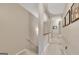 Hallway with carpet floors, wall art, and an open staircase at 2083 Hasel St, Lawrenceville, GA 30044