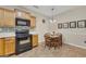 Eat-in kitchen featuring stainless steel appliances, tile flooring and wooden cabinetry at 2083 Hasel St, Lawrenceville, GA 30044