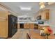 The bright kitchen features wooden cabinets, black appliances, and a decorative backsplash at 2083 Hasel St, Lawrenceville, GA 30044