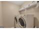 Functional laundry room featuring a washer and dryer with wire shelving above at 2083 Hasel St, Lawrenceville, GA 30044