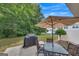 Outdoor patio space with table, chairs, a grill, and a large shade umbrella for relaxing or entertaining at 2083 Hasel St, Lawrenceville, GA 30044