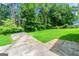 Backyard featuring a patio and lush green lawn, perfect for relaxing or entertaining amidst mature trees at 2117 Chestnut Hill Circle Cir, Decatur, GA 30032