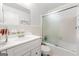 Clean bathroom featuring a vanity, mirrored wall, and glass-enclosed shower-tub combo at 2117 Chestnut Hill Circle Cir, Decatur, GA 30032