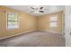 Bedroom with neutral carpeting, ceiling fan and two windows with natural light at 2117 Chestnut Hill Circle Cir, Decatur, GA 30032