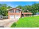 Charming two-story brick home with a well-manicured lawn and a two-car garage at 2117 Chestnut Hill Circle Cir, Decatur, GA 30032