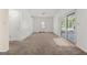 Spacious living room features neutral carpet, window and sliding glass door to the backyard at 2117 Chestnut Hill Circle Cir, Decatur, GA 30032