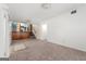 View of the large living room with carpeting, adjacent to the stairway and kitchen area at 2117 Chestnut Hill Circle Cir, Decatur, GA 30032