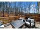 The spacious back deck offers an outdoor living space with wood railing and furniture at 234 Retreat Ln, Canton, GA 30114