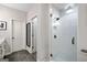 Modern bathroom with a glass shower enclosure and tiled floors, with a doorway into another room at 234 Retreat Ln, Canton, GA 30114
