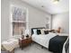 Cozy bedroom with natural light, a full size bed, and side table with lamp, desk with chair at 234 Retreat Ln, Canton, GA 30114