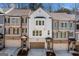 Townhomes with stylish exteriors, featuring brick accents, individual garages, and well-maintained landscaping at 234 Retreat Ln, Canton, GA 30114