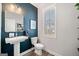 Elegant half bathroom with a pedestal sink, modern fixtures, and a large window at 234 Retreat Ln, Canton, GA 30114