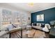 Stylish home office featuring natural light, a modern desk, and a comfortable seating area at 234 Retreat Ln, Canton, GA 30114