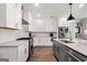 Bright kitchen with white cabinets, stainless steel appliances, and granite countertops at 234 Retreat Ln, Canton, GA 30114