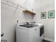 Modern laundry room featuring a stacked washer and dryer and storage, illuminated by recessed lighting at 234 Retreat Ln, Canton, GA 30114