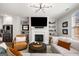 Open living room with a modern fireplace, built-in shelves, and stainless steel appliances in the kitchen at 234 Retreat Ln, Canton, GA 30114