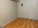 View of the basement with wood-look flooring and painted paneling at 6332 Valley Dale Dr, Riverdale, GA 30274