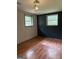 This bedroom offers lots of natural light with two windows and wood-look floors at 6332 Valley Dale Dr, Riverdale, GA 30274