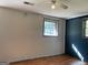A secondary bedroom with hardwood floors and a window letting in natural light at 6332 Valley Dale Dr, Riverdale, GA 30274