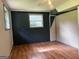 Bedroom with wood-look floors, a ceiling fan, and natural light from a window at 6332 Valley Dale Dr, Riverdale, GA 30274