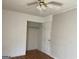 Bedroom with hardwood floors, ceiling fan, closet, and white walls ready for personalization at 6332 Valley Dale Dr, Riverdale, GA 30274