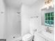 Bright white bathroom with a shower and bathtub combo, a toilet, and sink at 191 High Creek Dr, Roswell, GA 30076