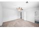 Large bedroom with neutral carpet, ceiling fan, and doors to an adjoining bathroom and walk-in closet at 191 High Creek Dr, Roswell, GA 30076