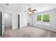 Spacious bedroom features neutral carpet, ceiling fan, and a view to the outdoors at 191 High Creek Dr, Roswell, GA 30076