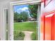 View through the front door to a green front lawn, trees, and houses across the street at 191 High Creek Dr, Roswell, GA 30076