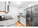 Modern kitchen features stainless steel appliances, sleek countertops, and ample storage space at 191 High Creek Dr, Roswell, GA 30076