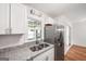 Bright kitchen with stainless steel appliances, granite countertops, and a sink beneath a window at 191 High Creek Dr, Roswell, GA 30076