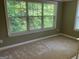 Cozy bedroom with a large window and neutral carpet at 2084 Cobblestone Ne Cir, Brookhaven, GA 30319