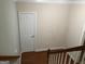 Hallway featuring hardwood floors, white trim and a storage closet at 2084 Cobblestone Ne Cir, Brookhaven, GA 30319