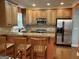 Modern kitchen with granite countertops, stainless steel appliances, and wooden cabinets at 2084 Cobblestone Ne Cir, Brookhaven, GA 30319