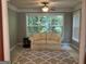 Bright living room with large window, neutral sofa and patterned rug at 2084 Cobblestone Ne Cir, Brookhaven, GA 30319