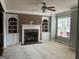 Bright living room features a fireplace with built-in shelving and large windows at 2084 Cobblestone Ne Cir, Brookhaven, GA 30319