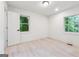 Bright bedroom featuring two windows and clean, light-toned hardwood floors at 4443 Flat Shoals, Decatur, GA 30034