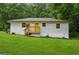 Charming home featuring a bright yellow door, grassy yard, and mature trees at 4443 Flat Shoals, Decatur, GA 30034